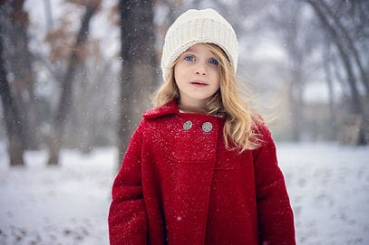 A young blonde girl in the snow in texas